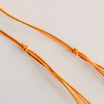 GUILA PARIS Cord Shell Necklace in Orange